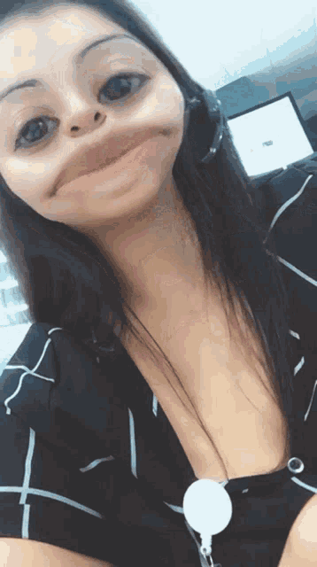 a woman in a black and white striped shirt making a funny face
