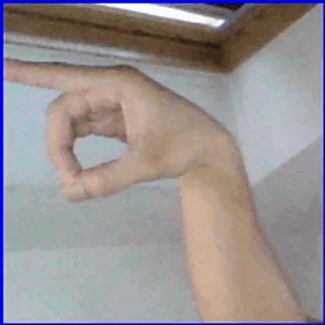 a person 's hand is making a circle with their finger