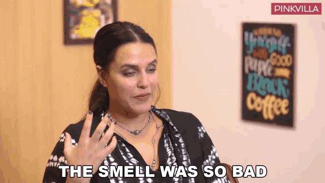 a woman says the smell was so bad in front of a pinkvilla sign