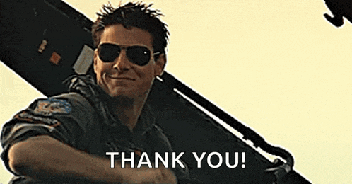a man wearing sunglasses is smiling and saying `` thank you '' while sitting on top of an airplane .