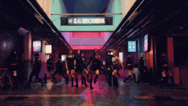 a group of people dancing in front of a sign that says lc records
