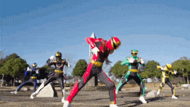 a group of power rangers are standing in a park