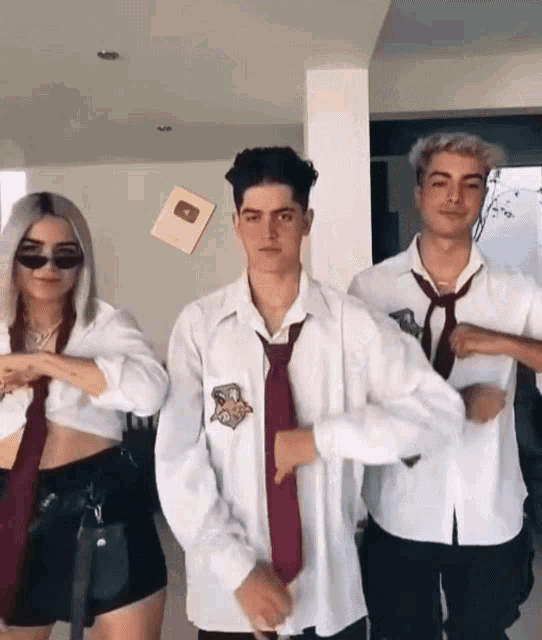 a group of people wearing white shirts and ties are dancing together
