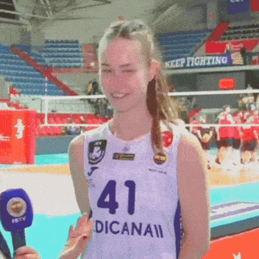 a woman wearing a white jersey with the number 41