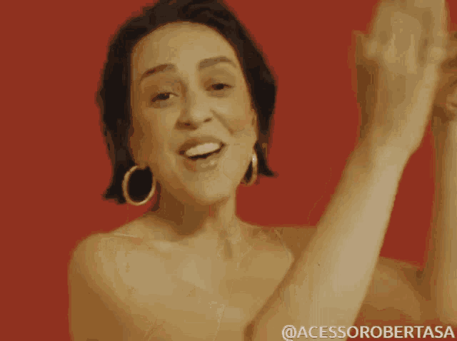 a woman without a shirt is dancing with her arms in the air and the caption says @acessorobertasa