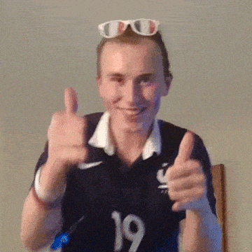 a man wearing a black shirt with the number 19 on it is giving a thumbs up sign .