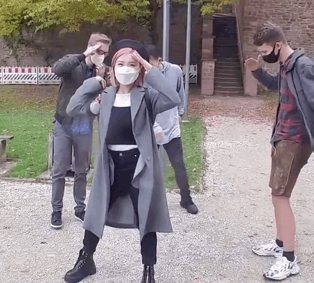 a group of people wearing face masks are standing next to each other .