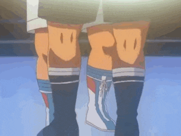 a couple of people standing next to each other with their legs crossed
