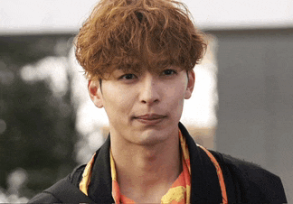 a close up of a man 's face with curly hair