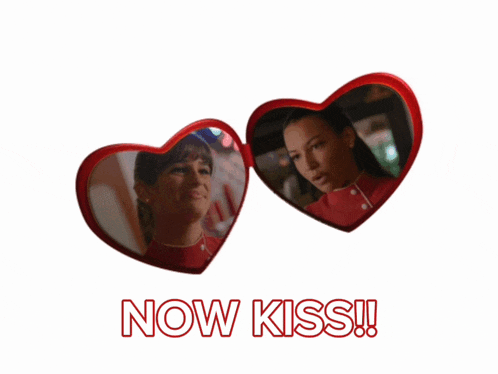 two red heart shaped mirrors with the words now kiss written on the bottom