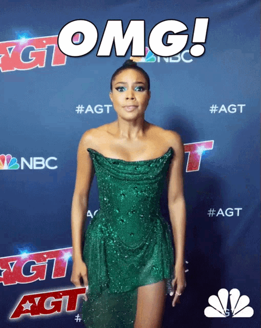a woman in a green dress is standing in front of a sign that says " omg "