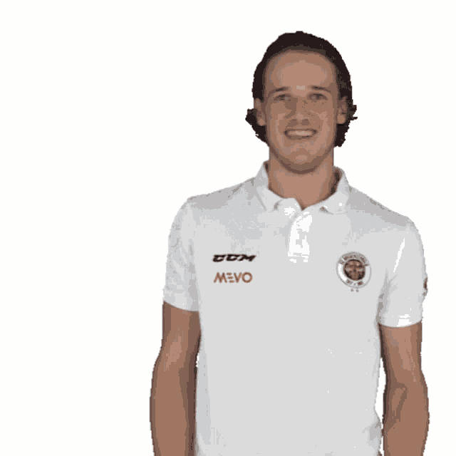 a man wearing a white polo shirt that says ccm on the front