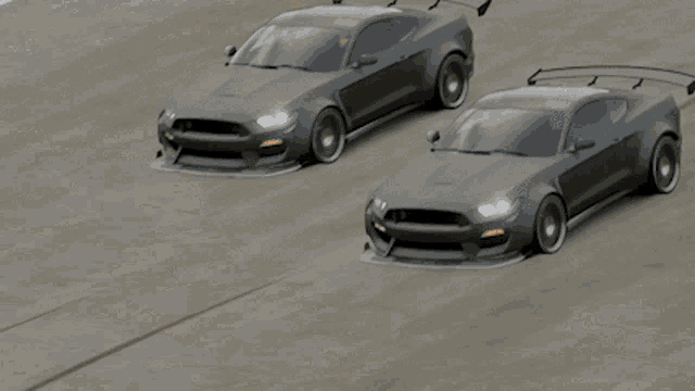 a gray sports car with a wing that says t on it