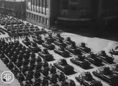 a black and white photo of a military parade with the letters tp on the bottom left