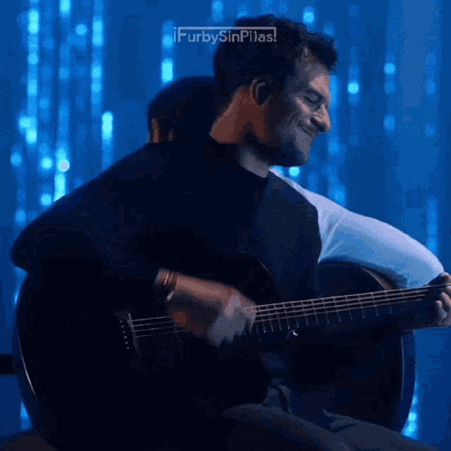 a man playing a guitar with the words ifurbysinpilas written on the bottom