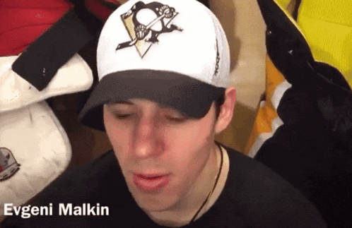 a man wearing a baseball cap with the name evgeni malkin on the bottom