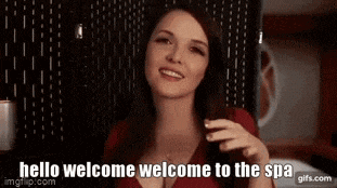 a woman in a red shirt is smiling and says hello welcome welcome to the spa .