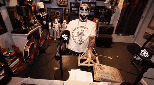 a man wearing a white shirt with a clown on it