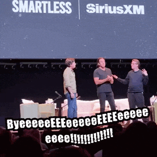 three men standing on a stage in front of a siriusxm sign