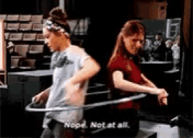 two girls are playing with hula hoops and one of them says nope not at all .
