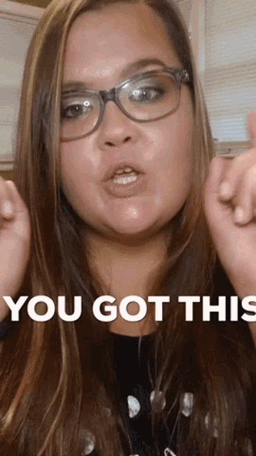 a woman wearing glasses says you got this in white letters