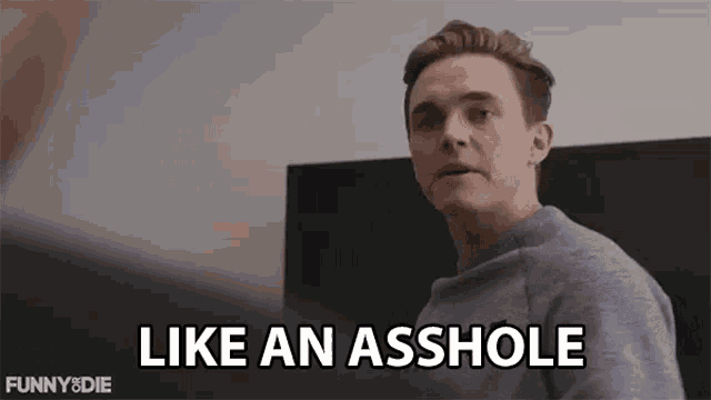 a man is sitting on a couch and says `` like an asshole '' .