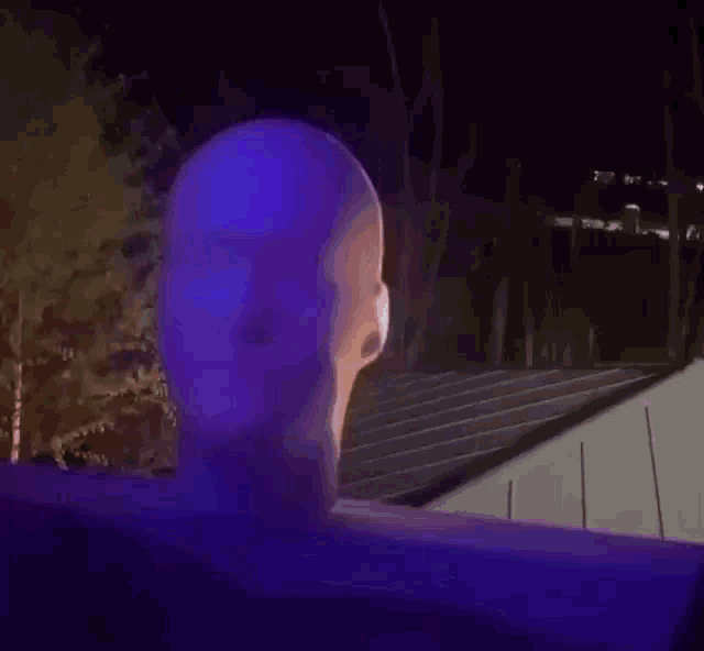 a purple light is shining on a building