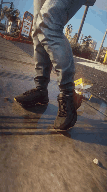 a person is skateboarding down a sidewalk with a store now open sign in the background