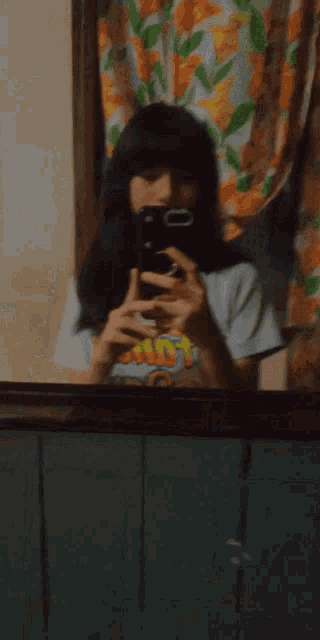 a person is taking a picture of themselves in a mirror while wearing a shirt that says hot