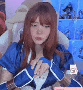 a woman with red hair is wearing a blue kimono and gloves