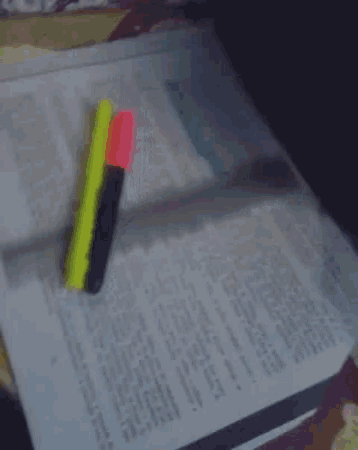 a ruler is laying on top of a piece of paper next to a pen