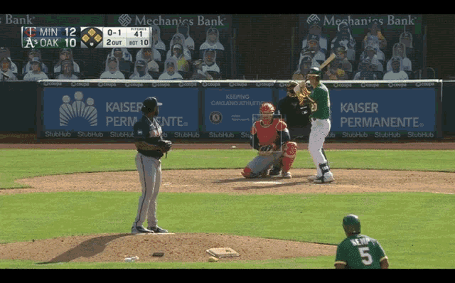 a baseball game is being played with a kaiser permanente banner