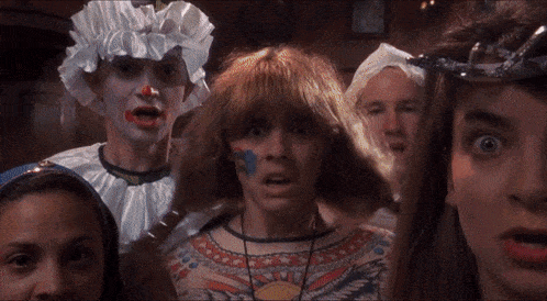 a group of children are dressed in costumes and one has a blue circle painted on her face