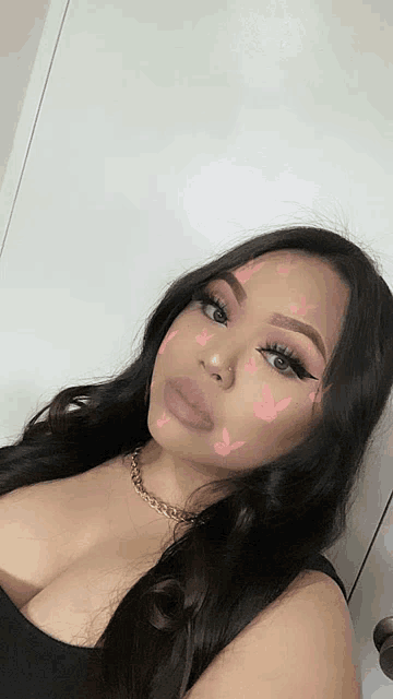 a woman with pink playboy bunny face paint on her face