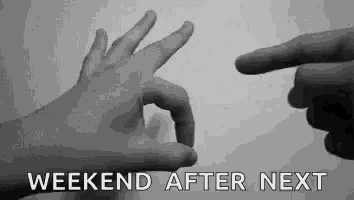 a couple of hands making an ok sign and pointing at each other in a black and white photo .