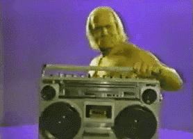 a man with a tattoo on his arm holding a boombox