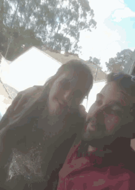 a man and a woman are posing for a photo