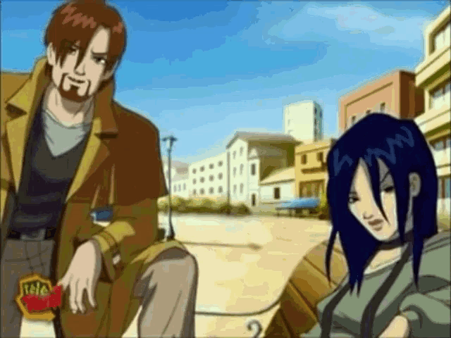 a man and a woman are standing in front of a building that says teletubbies