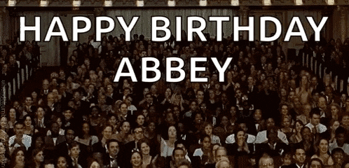 a large group of people are gathered in a room with the words happy birthday abbey written in white letters