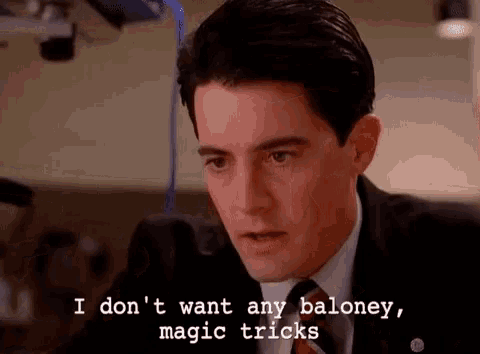 a man in a suit and tie says i don 't want any baloney , magic tricks .
