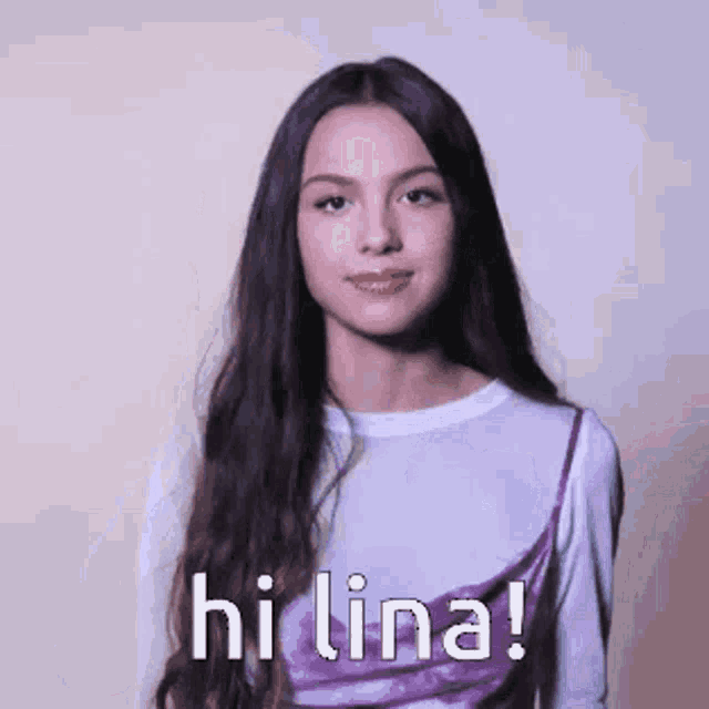 a girl with long hair is wearing a purple dress and a white shirt and says hi lina !