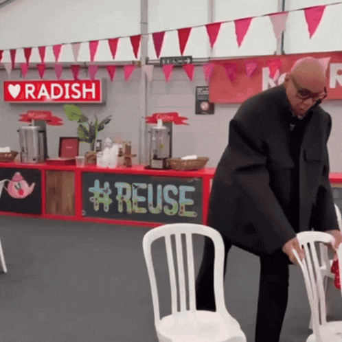 a man standing in front of a radish sign