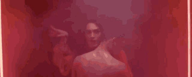a woman is standing next to a man in a red room .