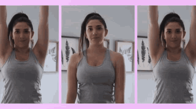 a woman in a gray tank top is lifting her arms up