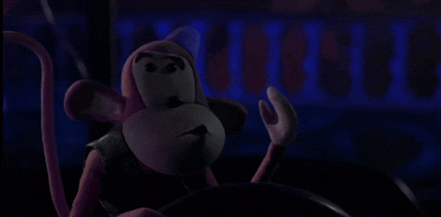 a pink monkey with a blue hat on looks angry