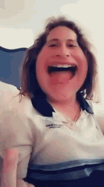 a woman is making a funny face with her tongue hanging out .