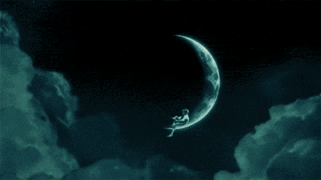 a man is sitting on a crescent moon fishing