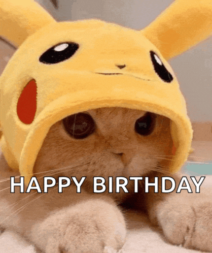 a cat wearing a pikachu hat with the words happy birthday written on it