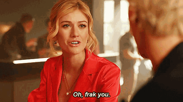 a woman in a red shirt is talking to a man and says " oh frak you "