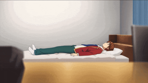 a boy is laying on a bed in a room